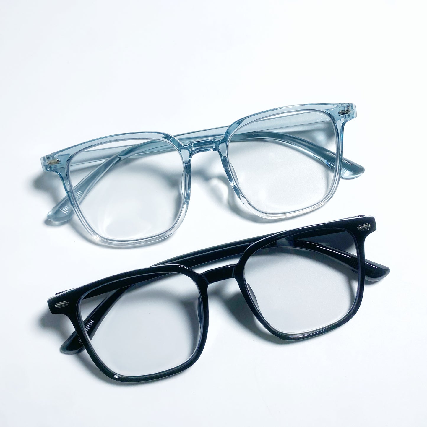 Two pairs of eyeglasses, one gradient blue and one black, on a white background.